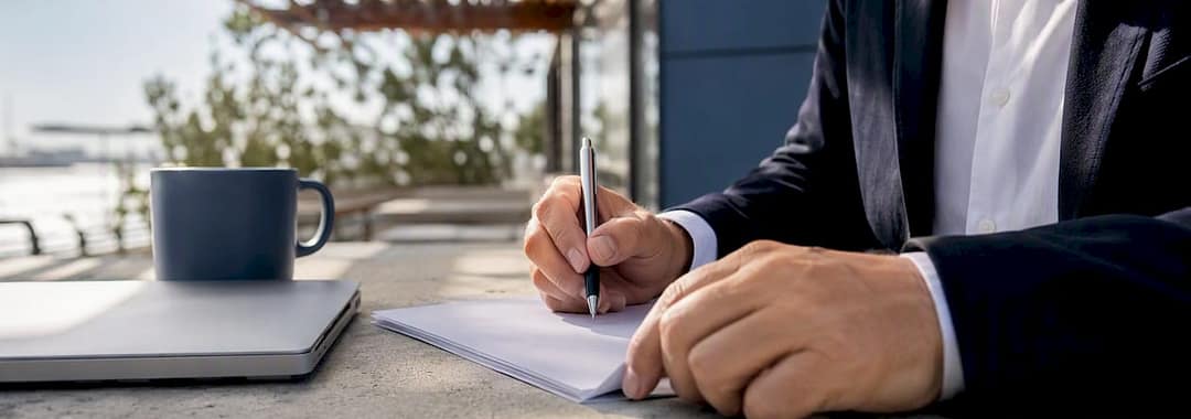 Hands signing temporary work contract