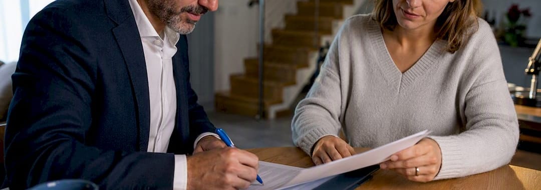 Hands signing a Portuguese telework agreement