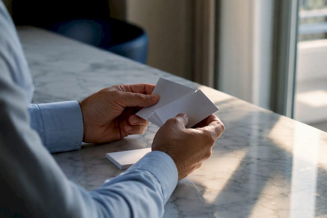 Hands counting blank business cards